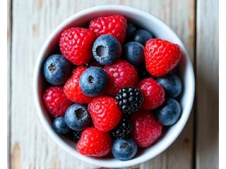 Vibrant bowl of mixed berries like blueberries, raspberries, and blackberries, representing antioxidant-rich superfoods.